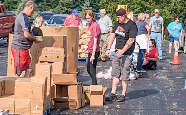 Volunteers sorting and assisting food into cars at Christ the King.