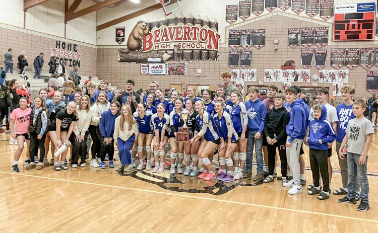 Gladwin’s volleyball team invited the fans from the stands to pose for a picture with the Cedar Cup, which the Flying G’s won last Wednesday night by sweeping a three-set match at rival Beaverton.