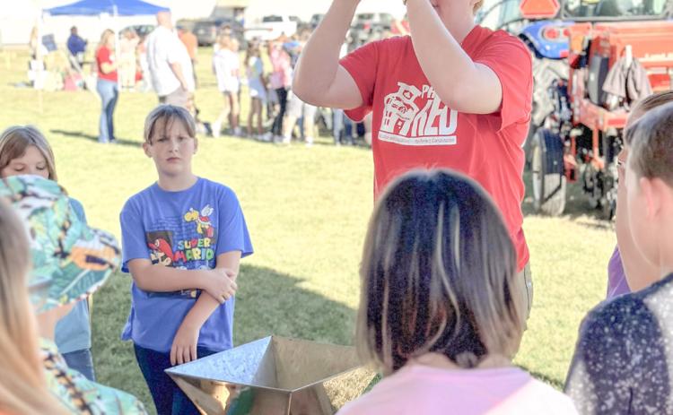 Fifth grade students learn about small farm animals at Farm Bureau’s Project RED hosted by Clare-Gladwin CTE.