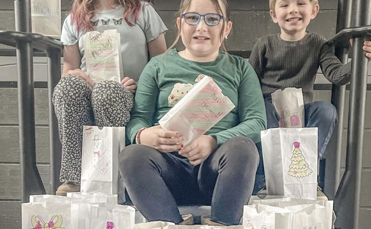 Pictured are Caroline, Logan, and Lily, the spirited children of Tyler and Angela McLaren. They are also the cherished grandchildren of Tina and Mike Haines, Kim and Pat Savage, and Mark and Amy Baker, all proud residents of Beaverton.