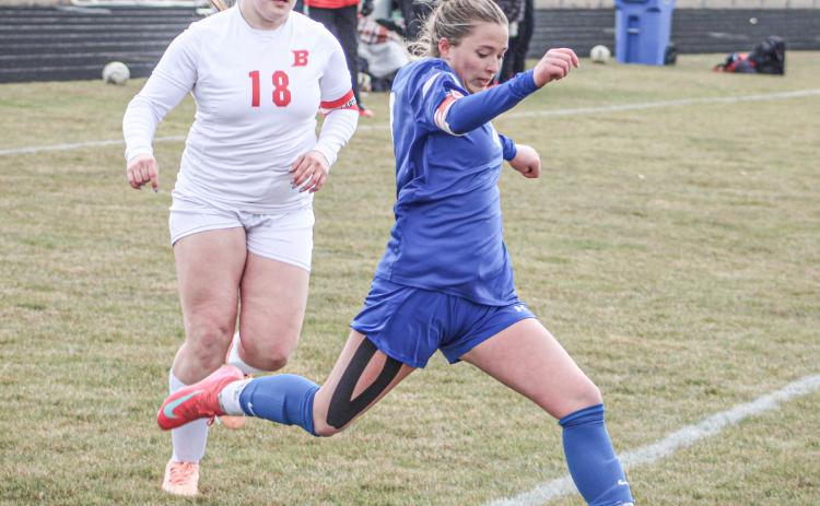 Gladwin’s Madisyn Lockwood gets ready to take a shot as Beaverton defender Sophia Milks closes in during last Ttuesday’s 3-1 victory for the Flying G’s.