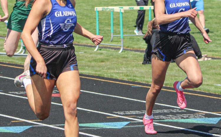 Gladwin’s Kamya Cajigas races to a school record in the 200 meters Saturday at the Jack Pine Conference Meet Saturday, just ahead of previous recordholder Breanna Campbell.