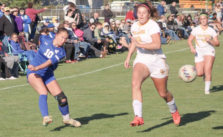 Gladwin’s Madisyn Lockwood fires a shot toward the Ogemaw Heights net during last week’s district tourney loss to the Falcons.