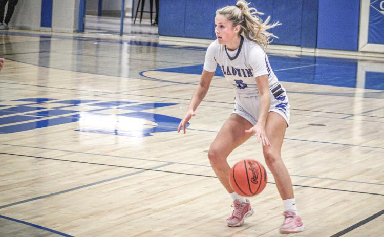 Gladwin point guard Breanna Campbell pounds the rock and looks for an opening in the defense during a recent game.