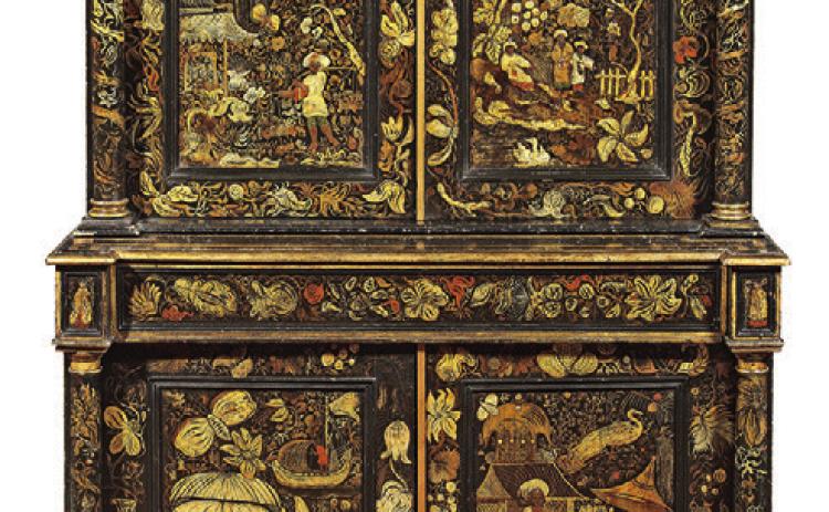 Repainting old furniture is not new. This cabinet was made around 1830, but the elaborate decorations were added later. KOVELS.COM