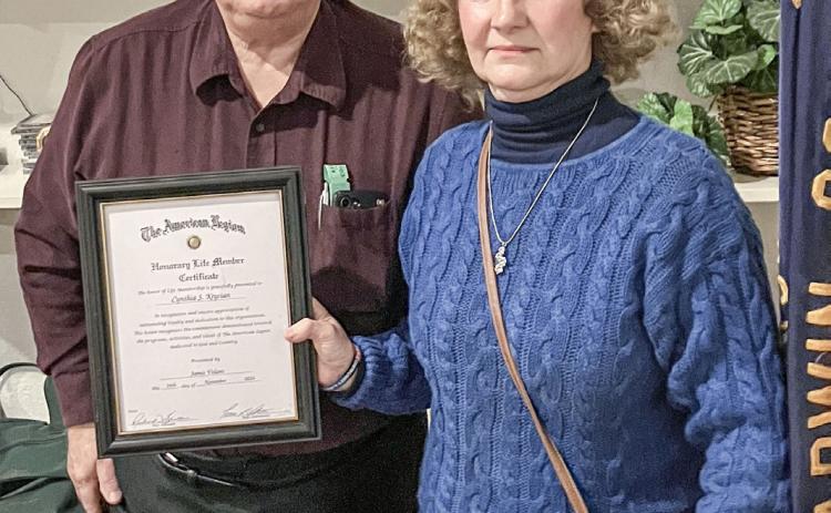 American Legion Post 171 Adjutant Rick Bratton presents Cynthia Krycian with a certificate declaring her an honorary member of the organization.
