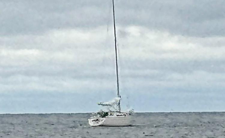 A sailboat remains stranded in Lake Huron, offshore of Point Au Gres, after two boaters from Ann Arbor ran aground and became stranded in rough water Tuesday. Michigan Department of Natural Resources conservation officers were able to safely rescue and return both boaters to shore.