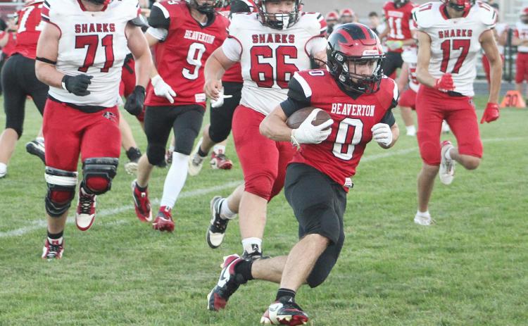 Beaverton’s Ty Wicke runs away from a pursuing pack of massive St. Louis Sharks during Friday night’s victory.