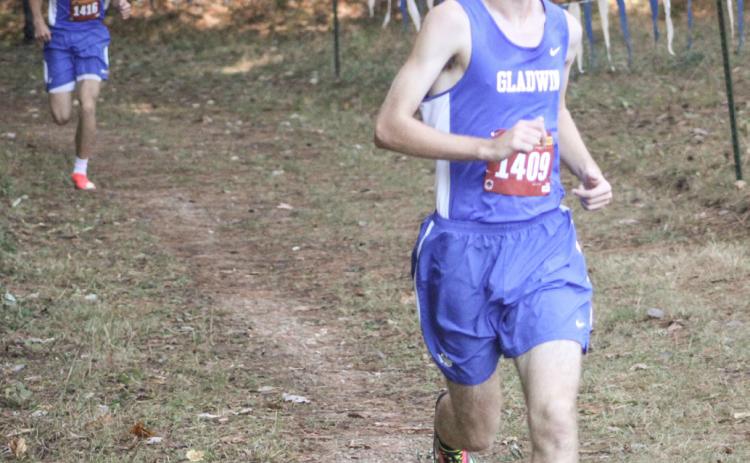 Gladwin’s Elijah Christensen rolls to the finish line first at the Cedar Bend Invitational Saturday at the Gladwin County Recreation Area.