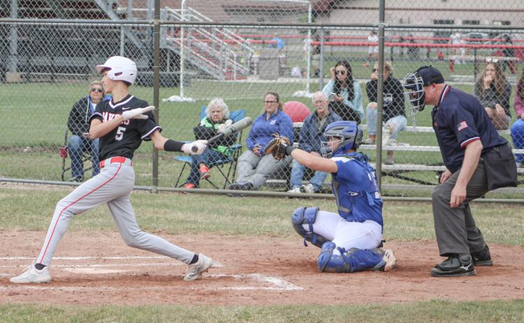 Beaverton’s Jace Mishler hits the ball during the first game of last Tuesday’s doubleheader split with visiting rival Gladwin.