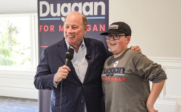 Candidate for Governor Mike Duggan and one of his biggest local supporters, Beaverton Junior High School student Tanner Oard, meet the people at a rally at Riverwalk Grill Saturday.