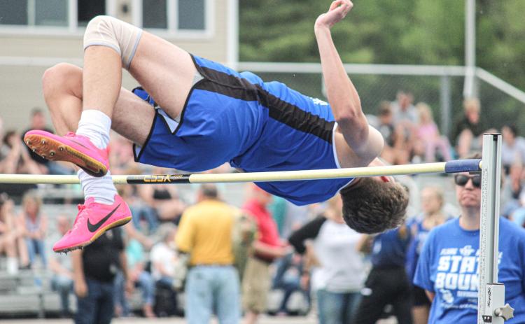 Clearing the pole in the high jump event.