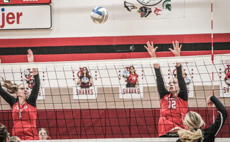 Braylin Orton and Trinity Danielak defend the net during a recent match. The Beavers snapped a three-game losing streak with a win last Wednesday.