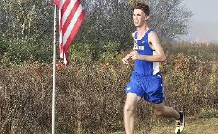 Gladwin’s Elijah Christensen ran past Old Glory and his own school record Saturday at the Veterans Serving Veterans Invitational.