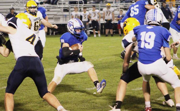 Gladwin’s Jacob Pahl high steps into an opening in the Standish-Sterling defense during the fourth quarter.
