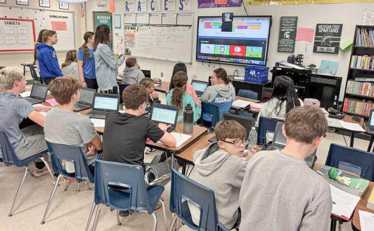 Students and co-workers get a FaceTime update from Gladwin Junior High School eighth grade English teacher Kim Kaleto (inset) live from the Boston Marathon last week.