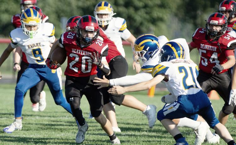 Beaverton’s Remington Brethour tries to elude a pair of would-be Evart tacklers during the Beaverton JV football team’s 0-0 tie Thursday. PHOTO BY JESSICA KELLER