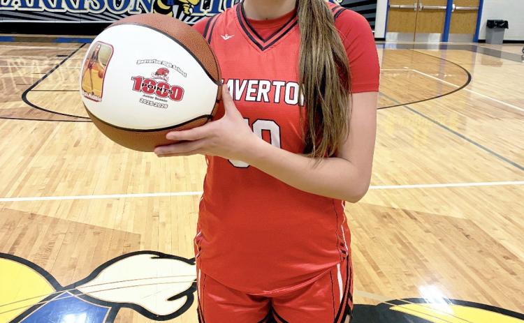 Beaverton junior Myah Hubble shows off the personalized basketball she received Thursday night after passing the milestone for 1,000 career points in a 78-48 victory at Harrison. Needing 17 points pregame to reach the magic number, Hubble finished with a game-high 37.