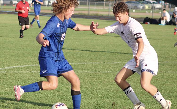Gladwin’s Ryder Johnson takes on the defense in front of the net during Thursday’s victory over Ithaca.