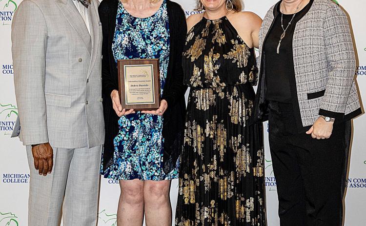Pictured left to right: Dr. L. Marshall Washington, MCCA Board Chair; Dr. Debra Daniels, 2026 Outstanding Alumnus Award recipient; Brandy Johnson, President of MCCA; and Dr. Michelle Allmendinger, President of Delta College.