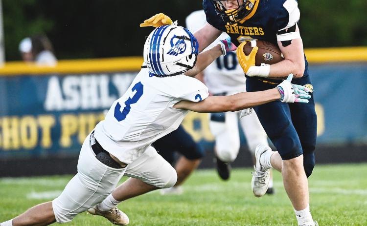 Logan Shell brings down a ball-carrier during Friday night’s victory at Standish in the Jack Pine Conference opener. MINDY STOKOSZYNSKI