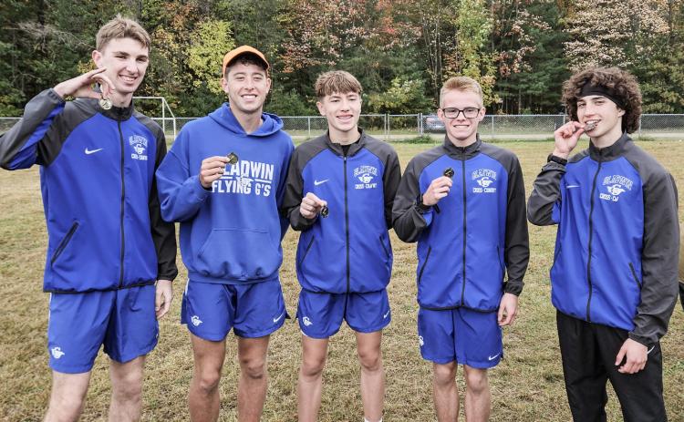Gladwin’s (left to right) Elijah Christensen, Caleb Palmreuter, Ben Verellen, John Whitman and Myles Robinson enjoy an invitational victory at Meridian.