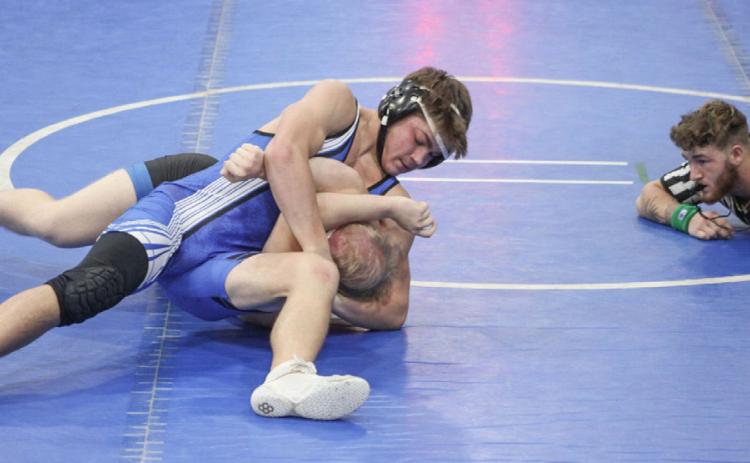 Gladwin’s Lorcan Keatley applies a headlock during a recent match. The Flying G’s swept a tri-meet at Evart to open the season last week.
