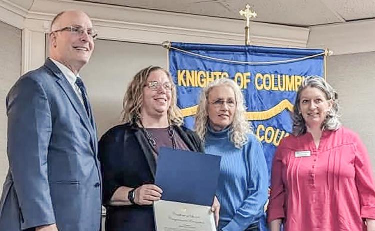 Prior to addressing the recent Gladwin County Chamber of Commerce Legislative Breakfast, Congressman John Moolenaar presented a Certificate of Special Congressional Recognition to Gladwin City-County Transit in honor of its 50th year of community service. At the podium are (left to right) Moolenaar, Transportation Director Kim Bruner, Executive Director Lori Stout and Chamber Director Carrie Will.