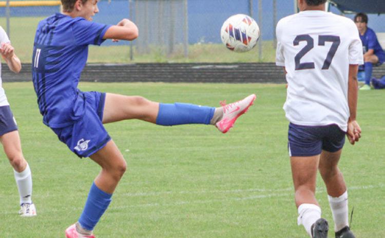 Gladwin’s Keaton Mausolf boots one out of the air during a recent game.