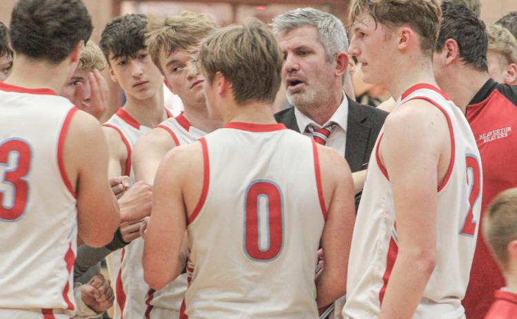 Beaverton coach Shad Woodruff talks strategy with the troops during a timeout in the waning moments of Friday night’s loss to Bullock Creek.