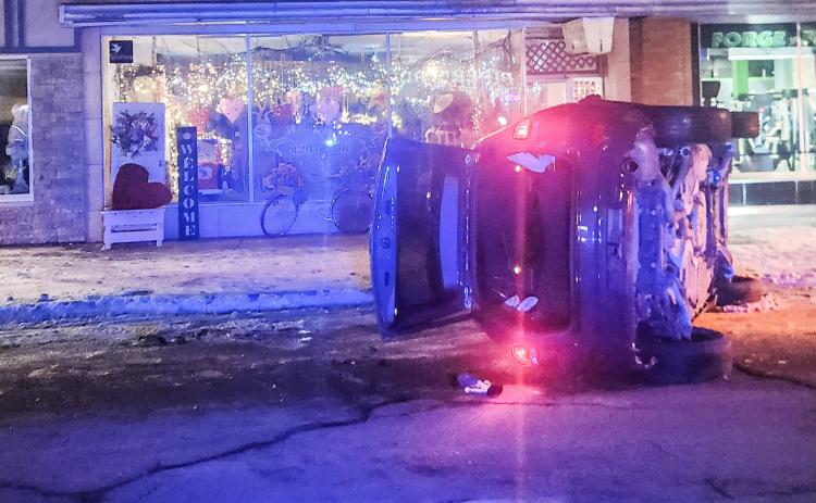 A Jeep Grand Cherokee flipped on its side after striking a parked car on Cedar Ave. last Tuesday night, shutting down traffic downtown for nearly two hours.