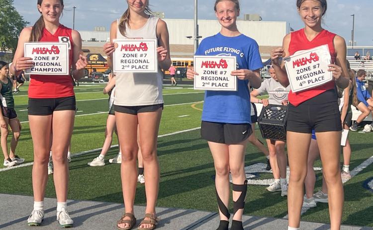 Gladwin Junior High’s Aria Rule (third from left) takes to the podium after placing second at the regional in the high jump last week.