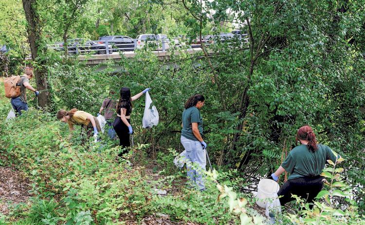 Volunteers clean up garbage along the Red Cedar River in East Lansing. MICHIGAN STATE UNIVERSITY