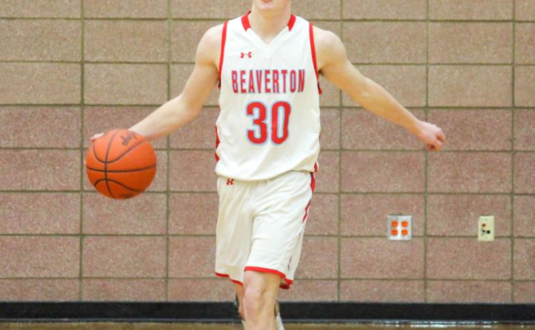 Junior Layk Woodruff, slow and confidently, dribbles the ball down the court