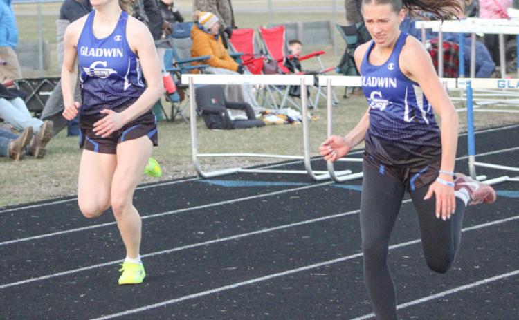 Gladwin hurdlers Charlotte Mawhorter (left) and Bree Visser sprint to the finish line during a recent meet.