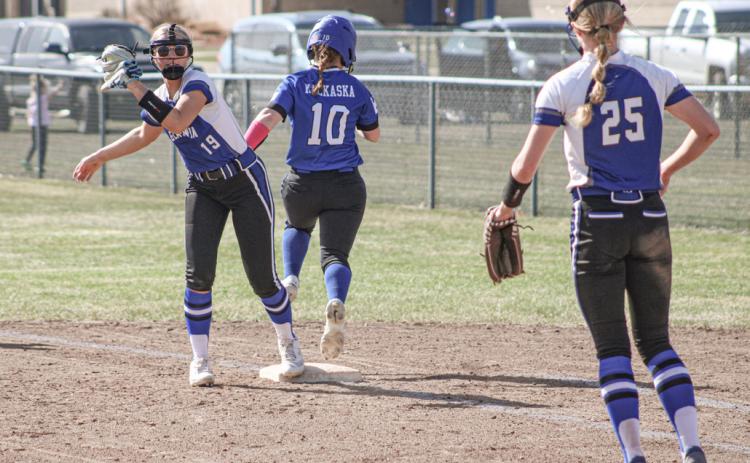 Gladwin’s Adree Ritchie completes a put-out at first base under the watchful gaze of pitcher Tessa Cameron.