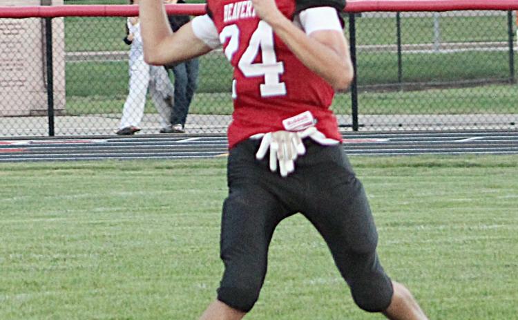 Beaverton quarterback Jace Mishler gets ready to deliver a pass during Thursday night’s loss to visiting Saginaw Michigan Lutheran Seminary.