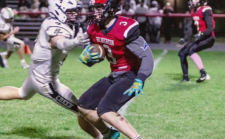 Beaverton’s Carter Kile tries to slip away from a Bullock Creek tackler during Friday night’s loss to the visiting Lancers. PHOTOS BY JESSICA KELLER