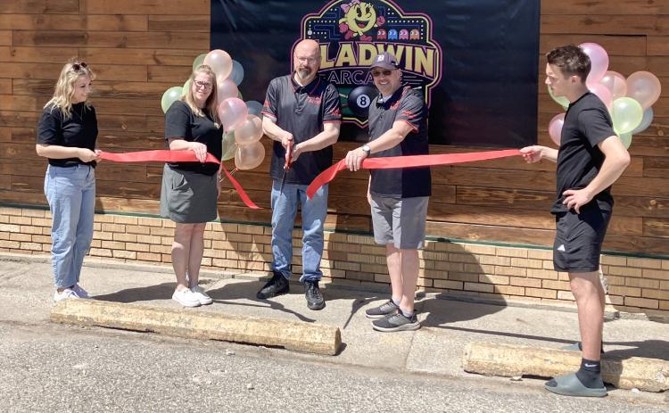 The new Gladwin Arcade on N. Silverleaf was officially opened during a ceremony Friday. Helping with the ribbon cutting were (left to right) Samantha Fessenden, Karyn Fessenden, Ryan Fessenden, Chris Dickens and Collin Fessenden.