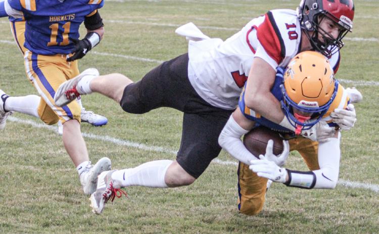 Beaverton’s Ian Roberts puts a stop to the forward progress of a Harrison ball-carrier Friday night. The Beavers fell to 2-2 on the season with a 36-20 loss.
