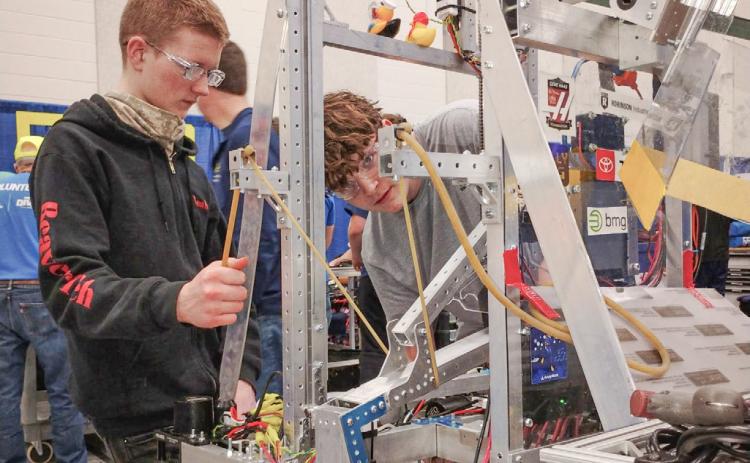Noah Burgess and Dylan Northrup work on assembling the BeaverTech robot prior to last weekend’s robotics competition at Midland Dow.