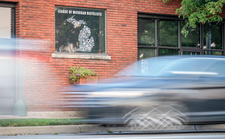 Cars pass in front of the League of Michigan Bicyclists office in Lansing. DONTÉ SMITH