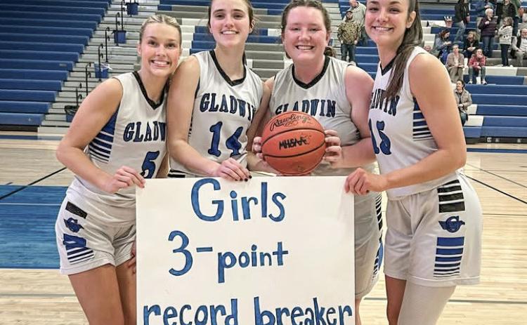 Gladwin seniors (left to right) Breanna Campbell, Abby Robinson, Sofia Sorensen and Ava Gary gather on Senior Night to celebrate Robinson’s new school record for 3-pointers in a season.