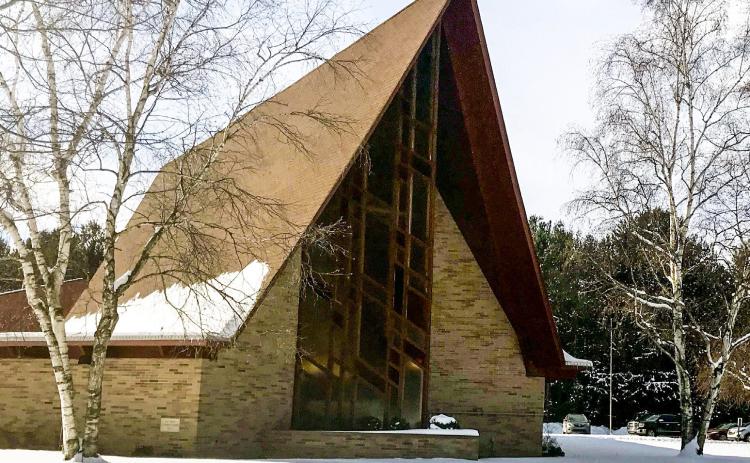 Pictured is Our Savior Lutheran Church. Inset photo, church members preparing sauerkraut for the supper.
