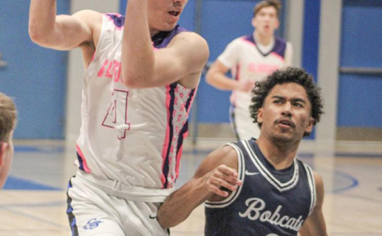 Gladwin’s Ben Verellen crashes into the paint during last week’s victory over visiting Bay City John Glenn on Coaches Vs. Cancer Night.