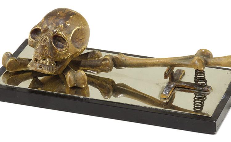 This paper clip features a bronze skull and bones, making it ready for Halloween any time of the year. Is it a modern-day memento mori or a comment on the tedium of paperwork? KOVELS.COM