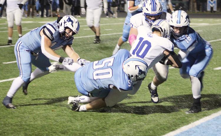 Jason Pahl is hit at the 1-yard line before falling into the end zone for a touchdown during the second half of Gladwin’s 28-13 loss at Meridian Friday night.