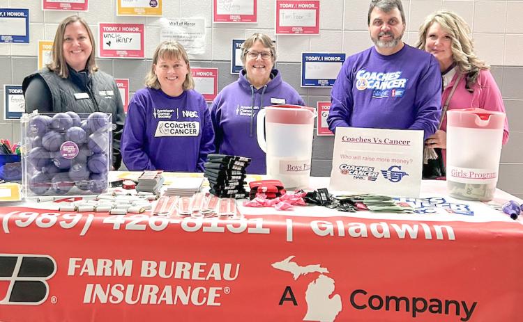 Taking care of the Farm Bureau Insurance sponsor’s table at last year’s Coaches vs. Cancer basketball game at Gladwin were (left to right) Mary Lynn Robertson, Kim Beebe, Heidi Varner, Duane Simpkins and Lisa Simpkins.