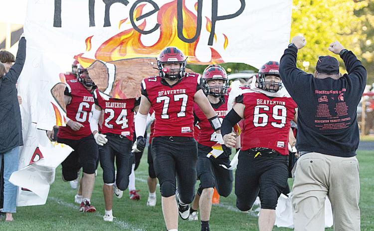 The Beaverton football team breaks the paper and takes the field with fire prior to a big 54-8 victory over Pinconning Friday night that put a triumphant stamp on an eventful Homecoming weekend for the community. See the story on B- 1! PHOTO BY JESSICA KELLER