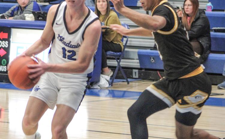 Gladwin’s Jacob Pahl looks inside for an open teammate during Thursday night’s impressive victory over visiting Ogemaw Heights.
